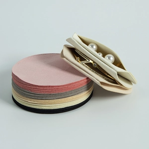 Detailed pile of colorful microfiber round jewelry pouches for storage and protection