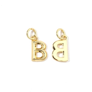 Macro shot of 18K gold plated letter B charms with polished finish for DIY jewelry