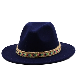 Detailed shot of navy blue wool fedora hat featuring a colorful woven pattern band
