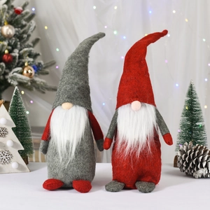 Set of grey and red Christmas gnomes with knit hats and warm LED light background
