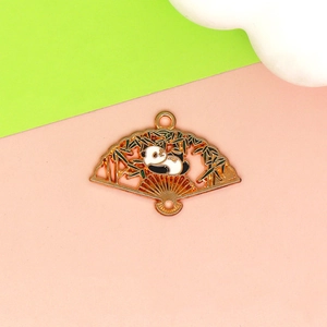Detail of fan-shaped gold panda charm with enamel bamboo motifs for DIY jewelry