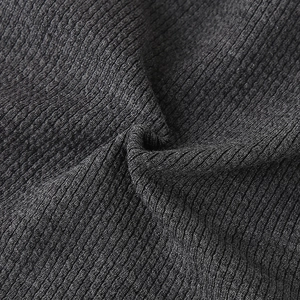 Close-up of charcoal grey ribbed knit texture showing thick elastic fabric detail