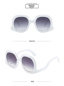 Front and side view of oversized white frame sunglasses with gray gradient lenses