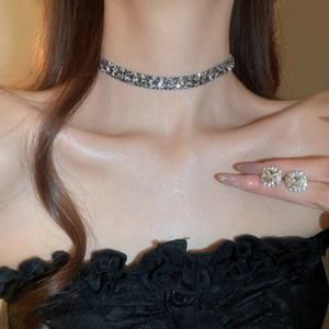 Close-up of model wearing silver zircon pendant necklace and square stud earrings set