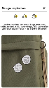 Close-up of speech bubble enamel pins with social quotes on a canvas bag accessory