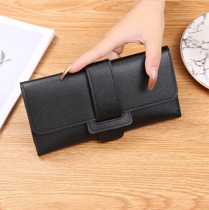 Detailed view of women's long black trifold wallet with lychee pattern leather and metal snap