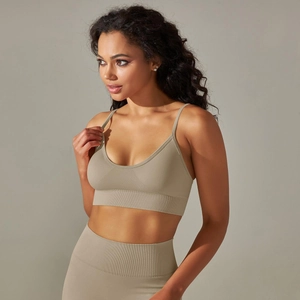 Close-up of seamless ribbed knit fabric on khaki sports bra and high-waist yoga pants