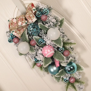 Christmas teardrop swag with blue and pink ornaments, white flocking and pine needles