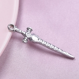 Detailed close-up of a 304 stainless steel sword pendant with intricate floral engravings