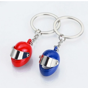 Detail of red and blue 3D mini motorcycle helmet keychains with chrome metallic visors