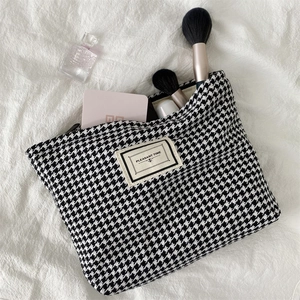 Classic houndstooth cosmetic bag for makeup storage with Pleasant Time woven label