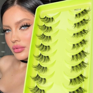 Close-up of 14 pairs of thick cross-style false eyelashes in a neon tray for lash extension