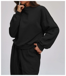 Detail of premium knit texture on black crewneck sweatshirt and matching jogger set