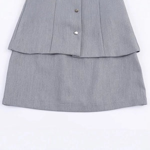 Grey crepe two-piece dress set featuring layered design and metallic button details