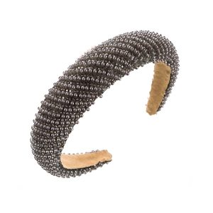 Close-up of dark grey artificial pearls on a thick headband with soft non-slip velvet lining