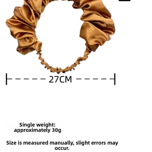 Close-up of pleated champagne satin headband with elastic band and 27cm ruched design