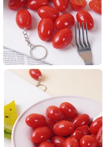 Realistic cherry tomato keychain pendant on a magazine with a metal fork detail