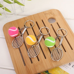 Detailed view of silver tennis racket keychains with mini pink, yellow and green balls