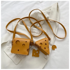 Close-up of yellow cheese-shaped mini bags in square and triangle styles with PU texture