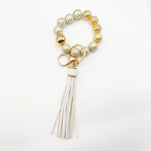 Detail of beaded tassel keychain featuring snakeskin patterns and golden silicone beads