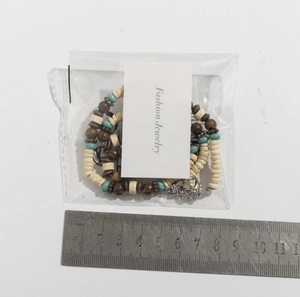 Detail view of Bohemian turquoise and wood bead necklace with ruler for size reference