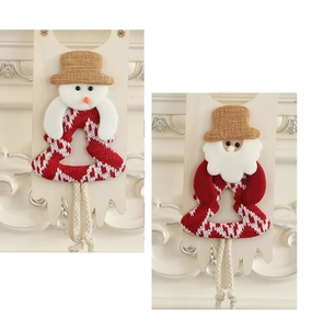 Detail of Christmas snowman and Santa door hangers with red knit fabric and linen accents