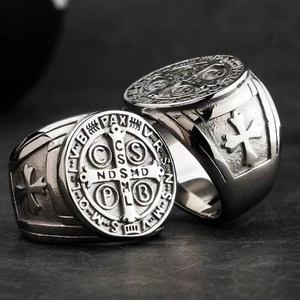 Macro shot of retro stainless steel St. Benedict medal ring with religious cross relief