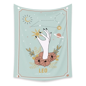 Close-up of mint green Leo tapestry with gold sun, flowers and astrology details