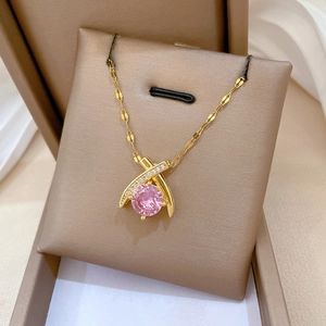Detail of cross water drop necklace with large pink gemstone and micro-inlaid zircon