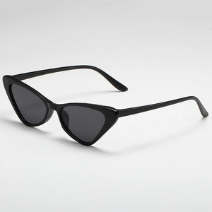 Detailed 45-degree angle view of vintage black cat-eye sunglasses with dark grey lenses