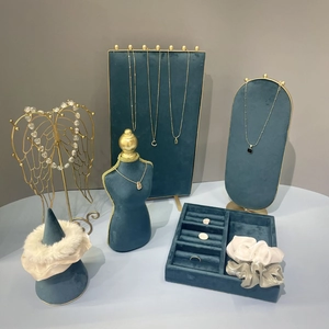 Teal velvet jewelry display set with gold metal frames for necklaces and rings