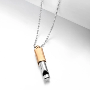 Detail of 528Hz meditation whistle pendant with brushed gold finish and 121.8 decibels engraving
