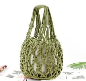 Detail of green woven mesh handbag with a beige drawstring inner canvas pouch