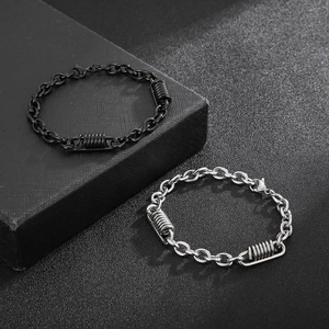 Close-up of black and silver stainless steel O-chain bracelets with spiral charms