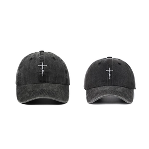 Detail view of washed cotton baseball caps with FAITH cross embroidery in two sizes