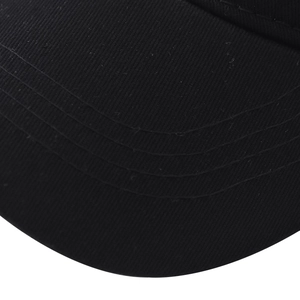 Detail of black cotton baseball cap brim showing four reinforced stitching rows