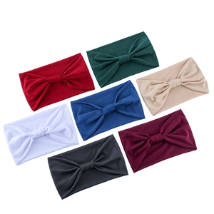 Close-up of wide stretch yoga headbands in seven solid colors with bow details