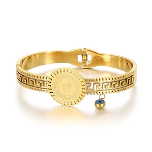Vintage gold portrait coin bracelet with evil eye charm and hollow greek key pattern