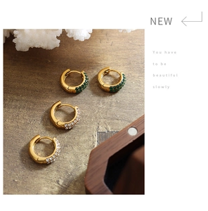 Close-up of 18K gold plated hoop earrings with green and white zircon pave setting