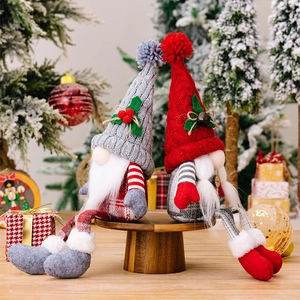 Detail of red and grey Christmas gnomes featuring knitted hats and long dangling legs