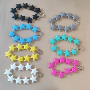 Colorful star-shaped silicone keychain wristlets with metal rings in various vibrant colors