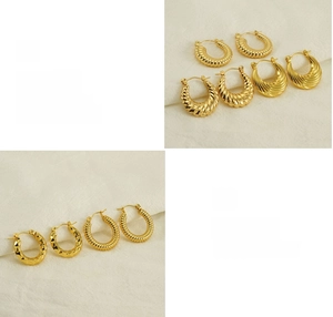 Detailed views of gold twisted hoop earrings showing polished texture and craftsmanship