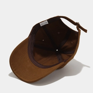 Detail view of cotton baseball cap interior showing sewing quality and washing label