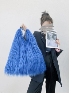 Detail of bright blue long-pile faux fur texture on a Y2K style plush tote bag