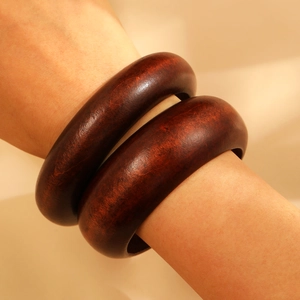 Sandalwood bangles set featuring natural wood grain and polished finish in deep red-brown