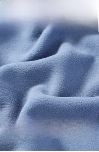 Close-up of the thick blue polar fleece lining of the plush vest for winter warmth