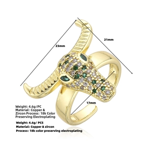 Macro detail of gold bull head ring with green cubic zirconia and 18k gold plating finish
