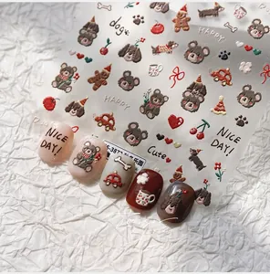 Detail of cartoon bear nail art stickers with sample nails on white textured paper