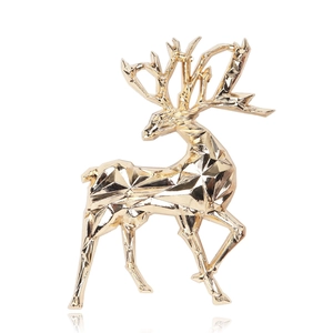 Polished gold 3D deer brooch with geometric facets on a white background