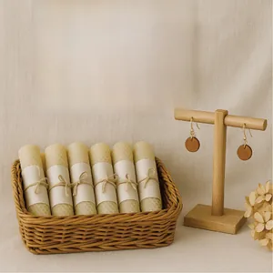 Handmade gift set with rolled beeswax candles in a wicker basket and wooden earrings